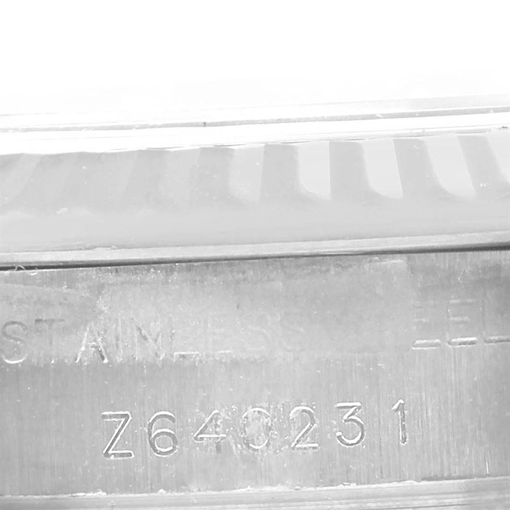 The image shows a close-up of the side engraving on a Rolex Oyster Perpetual 176234 Women
s Stainless Steel Black Dial 176234 Women
s Stainless Steel Black Dial watch, including the serial number.