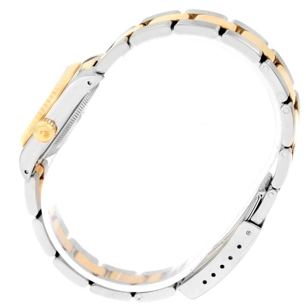 This image shows a side view of the Rolex Oyster Perpetual 67193 Women's Steel and Gold (two tone) Champagne Dial 67193 Women's Steel and Gold (two tone) Champagne Dial watch, focusing on its two-tone bracelet and crown.