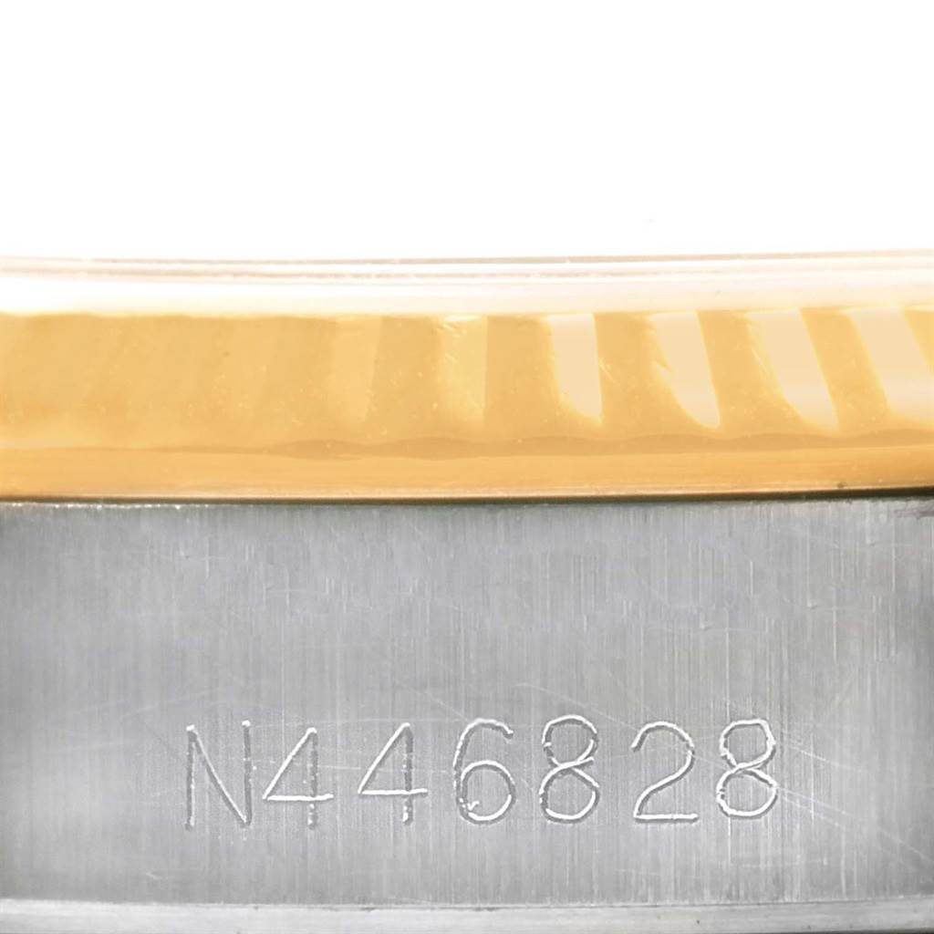 The close-up image shows the serial number engraving and part of the bezel of the Rolex Oyster Perpetual 67193 Women's Steel and Gold (two tone) Champagne Dial 67193 Women's Steel and Gold (two tone) Champagne Dial watch.