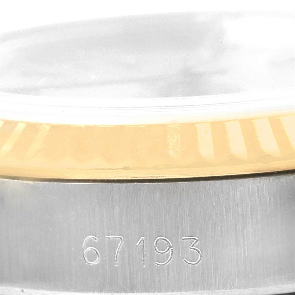 The image shows a close-up of the side of a Rolex Oyster Perpetual 67193 Women's Steel and Gold (two tone) Champagne Dial 67193 Women's Steel and Gold (two tone) Champagne Dial watch with a view of the model number 67193 and part of the bezel.