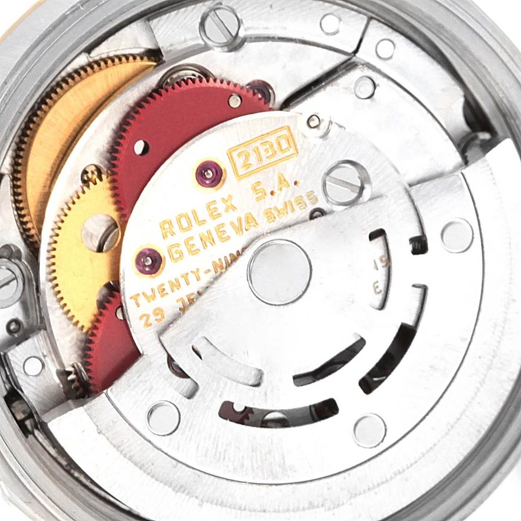 The image shows the internal mechanism and movement parts of a Rolex Oyster Perpetual 67193 Women's Steel and Gold (two tone) Champagne Dial 67193 Women's Steel and Gold (two tone) Champagne Dial watch, including gears and inscriptions.