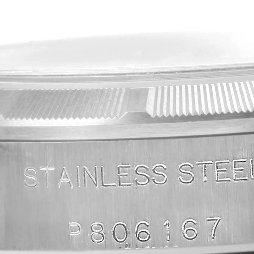 Side view of a Rolex Oyster Perpetual 76030 Women
s Stainless Steel Pink Dial 76030 Women
s Stainless Steel Pink Dial, showing the stainless steel casing and serial number.
