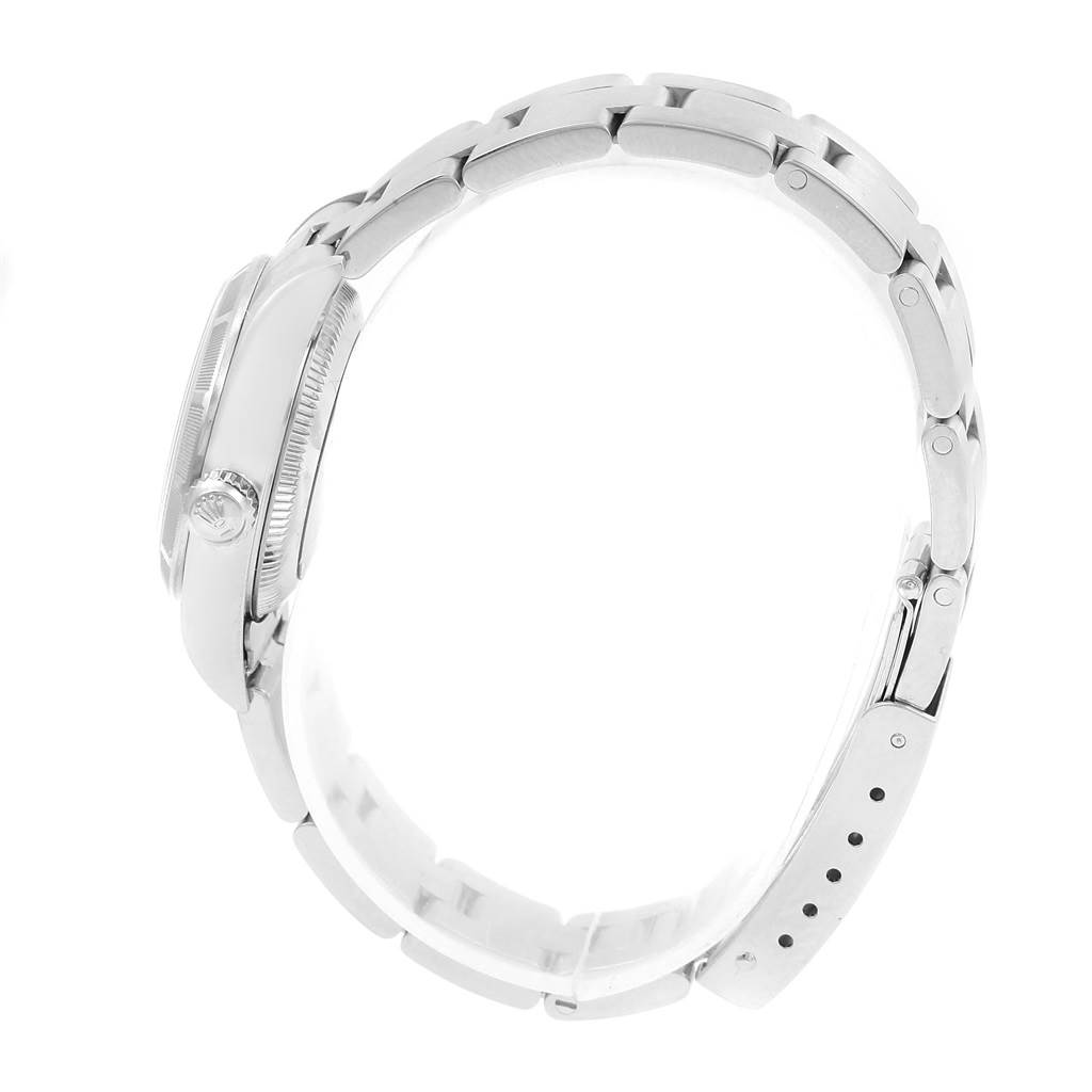 The image shows a side view of a Rolex Oyster Perpetual 76030 Women
s Stainless Steel Pink Dial 76030 Women
s Stainless Steel Pink Dial watch, highlighting the case, crown, and bracelet.