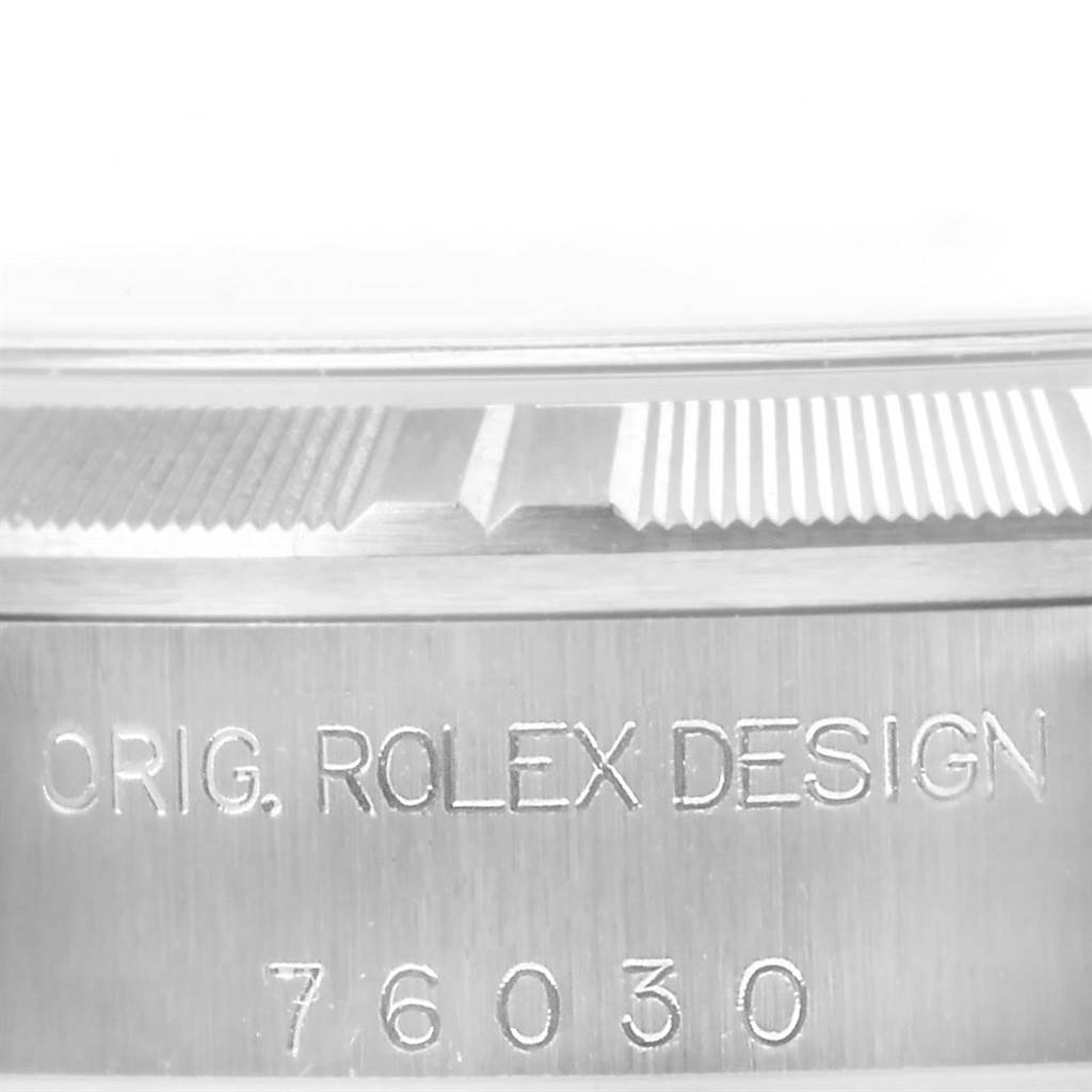 This image shows a close-up of the engraved bezel and case side of a Rolex Oyster Perpetual 76030 Women
s Stainless Steel Pink Dial 76030 Women
s Stainless Steel Pink Dial watch.