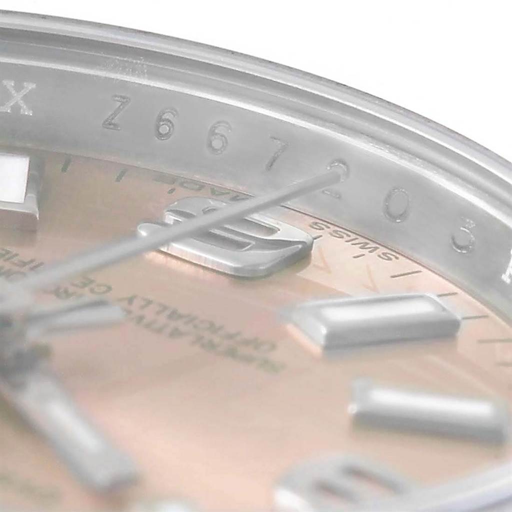 The close-up angle of the Rolex Oyster Perpetual 176210 Women's Stainless Steel Pink Dial 176210 Women's Stainless Steel Pink Dial watch shows a partial view of the dial, hour markers, hands, and inner bezel.
