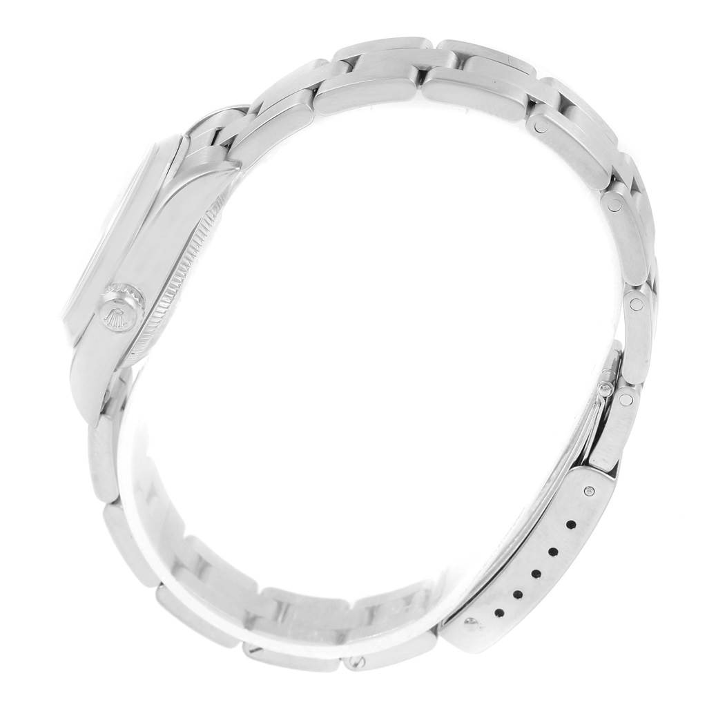 The image shows a side view of a Rolex Oyster Perpetual 76080 Women's Stainless Steel Black Dial 76080 Women's Stainless Steel Black Dial watch, highlighting its bracelet and side of the case with the crown.