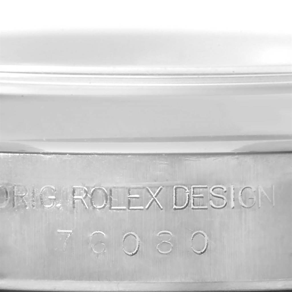 The image shows a close-up of the case side of a Rolex Oyster Perpetual 76080 Women's Stainless Steel Black Dial 76080 Women's Stainless Steel Black Dial watch, highlighting the engraved text.