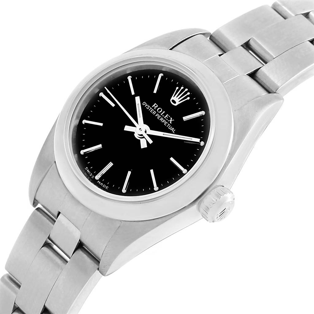 The image displays a close-up, angled view of a Rolex Oyster Perpetual 76080 Women's Stainless Steel Black Dial 76080 Women's Stainless Steel Black Dial watch, showing the dial, bezel, crown, and part of the bracelet.