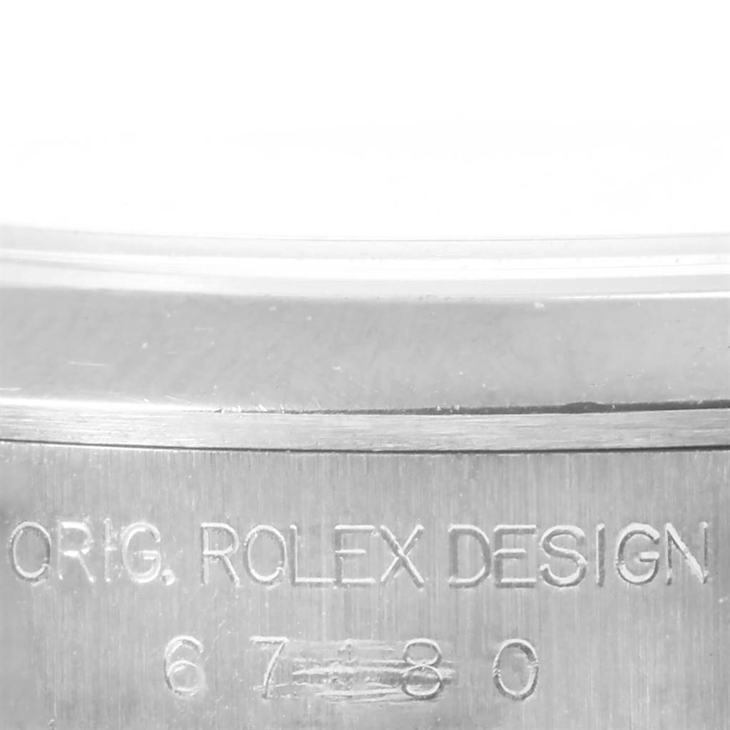 This image features a close-up of the engraved caseback of a Rolex Oyster Perpetual 67180 Women
s Stainless Steel Pink Dial 67180 Women
s Stainless Steel Pink Dial watch.