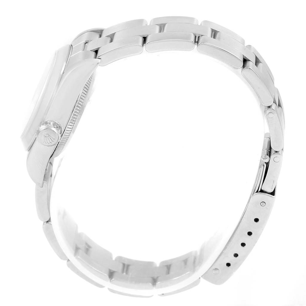 The image shows a side view of the Rolex Oyster Perpetual 67180 Women
s Stainless Steel Pink Dial 67180 Women
s Stainless Steel Pink Dial watch, featuring its metallic bracelet and clasp.