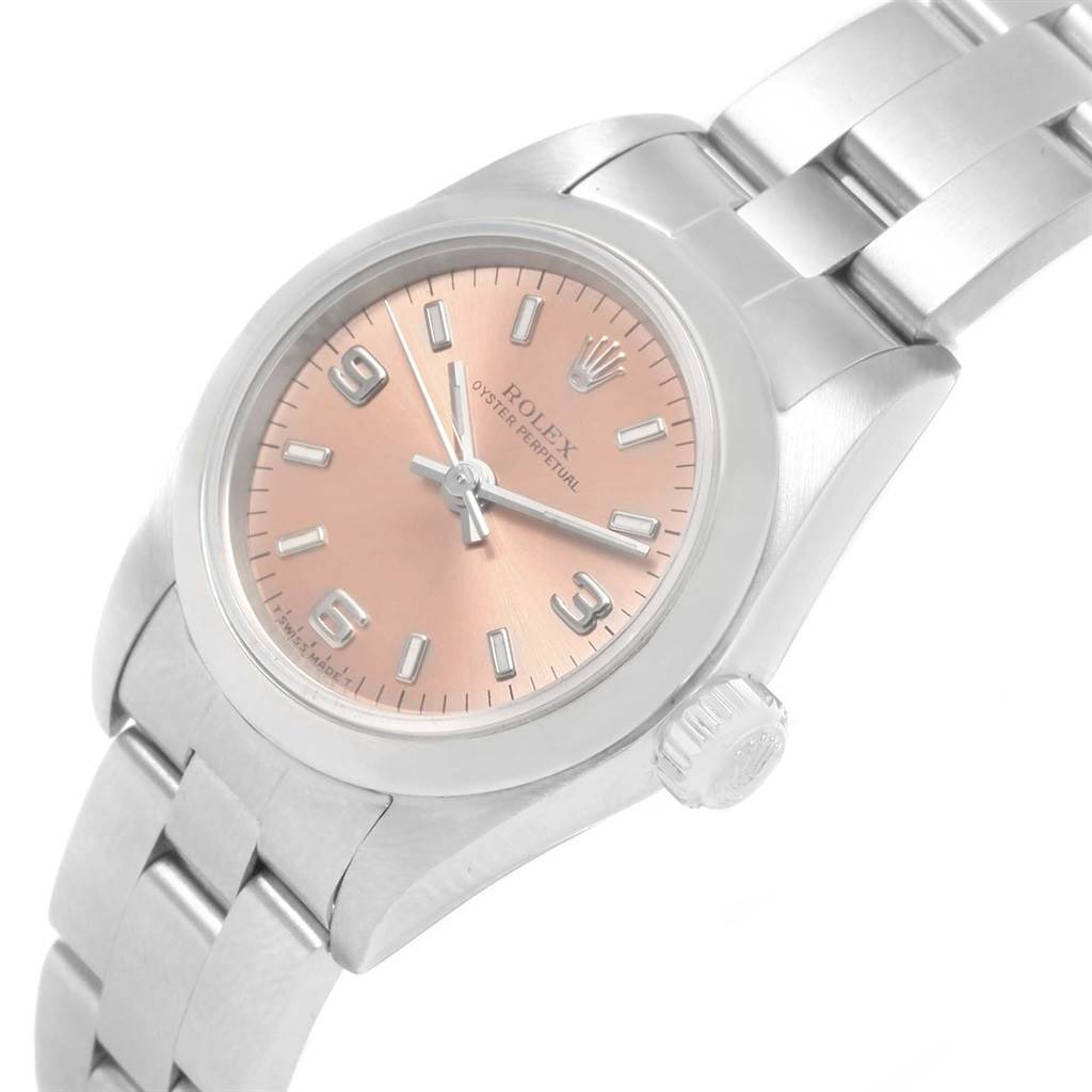 This image shows a close-up of a Rolex Oyster Perpetual 67180 Women
s Stainless Steel Pink Dial 67180 Women
s Stainless Steel Pink Dial watch angled to display the face, crown, and part of the bracelet.