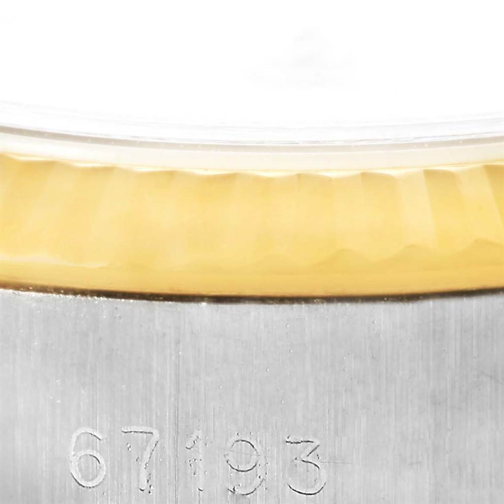 This image shows a close-up of the serial number on the case and the bezel edge of a Rolex Oyster Perpetual 67193 Women's Steel and Gold (two tone) White Dial 67193 Women's Steel and Gold (two tone) White Dial watch.