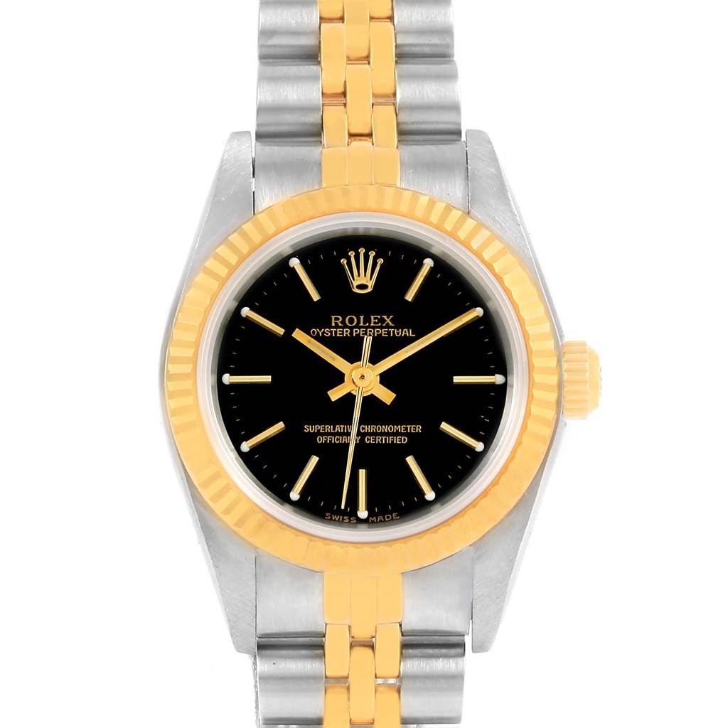 This image shows a Rolex Oyster Perpetual 76193 Women's Steel and Gold (two tone) Black Dial 76193 Women's Steel and Gold (two tone) Black Dial watch from a front angle, displaying its dial, bezel, and part of the bracelet.