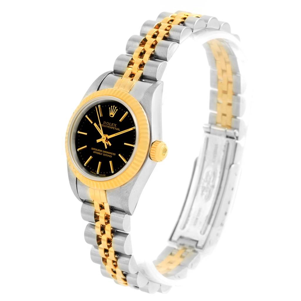 The image shows a Rolex Oyster Perpetual 76193 Women's Steel and Gold (two tone) Black Dial 76193 Women's Steel and Gold (two tone) Black Dial watch at a three-quarter angle, displaying its face, two-tone bezel, and bracelet.
