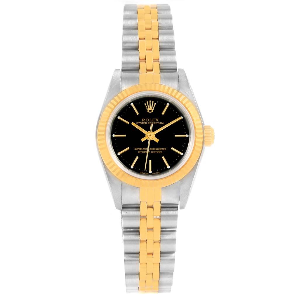 This Rolex Oyster Perpetual 76193 Women's Steel and Gold (two tone) Black Dial 76193 Women's Steel and Gold (two tone) Black Dial watch is shown from a top-down angle, featuring a gold and silver bracelet and a black dial.