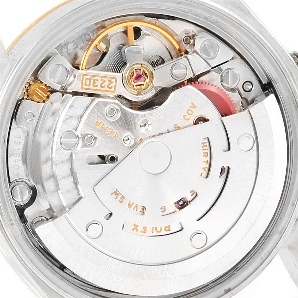 This is an internal view of the Rolex Oyster Perpetual 76193 Women's Steel and Gold (two tone) Black Dial 76193 Women's Steel and Gold (two tone) Black Dial model, showing its intricate movement components and mechanisms.