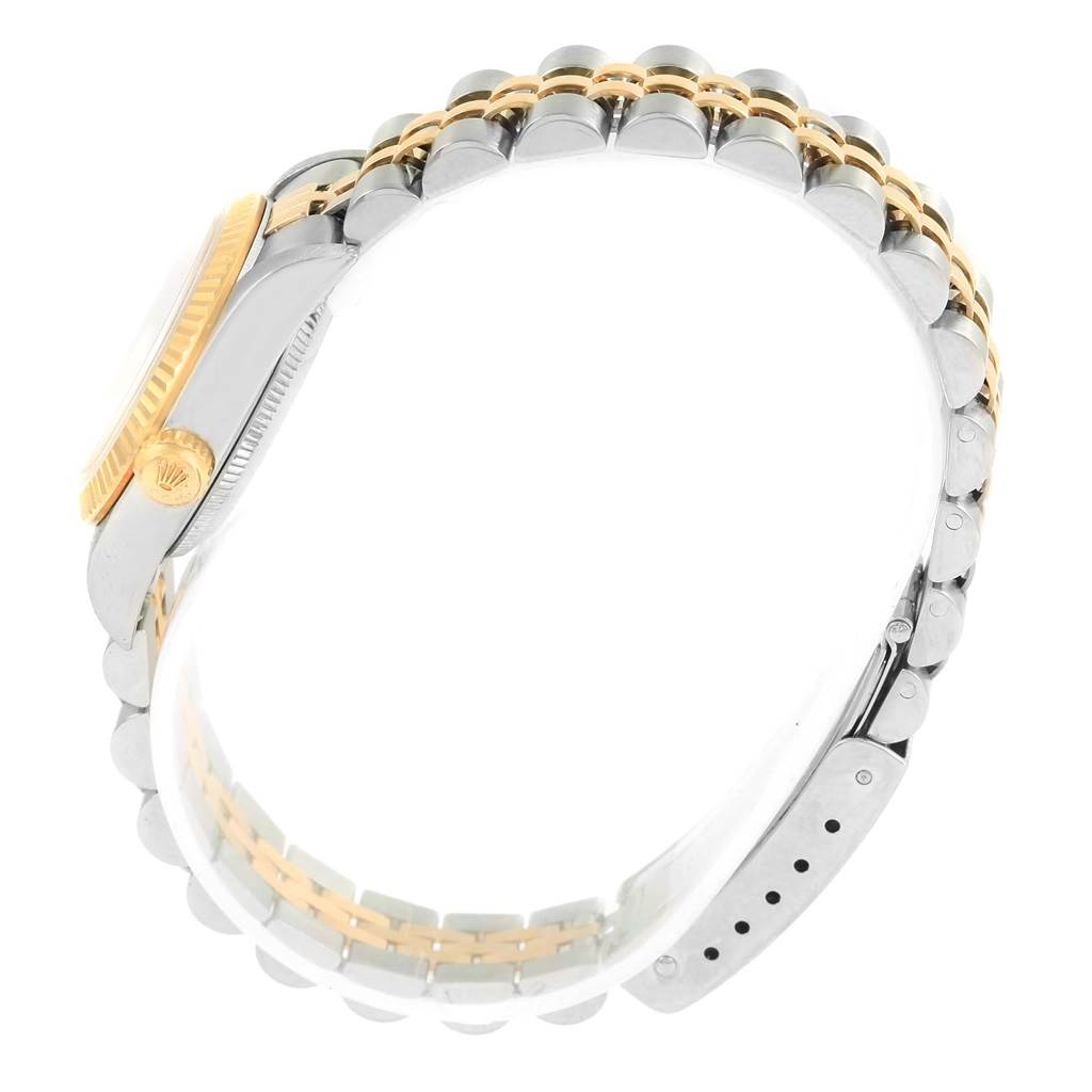 This side view of a Rolex Oyster Perpetual 76193 Women's Steel and Gold (two tone) Black Dial 76193 Women's Steel and Gold (two tone) Black Dial watch shows the bracelet, crown, and part of the case.