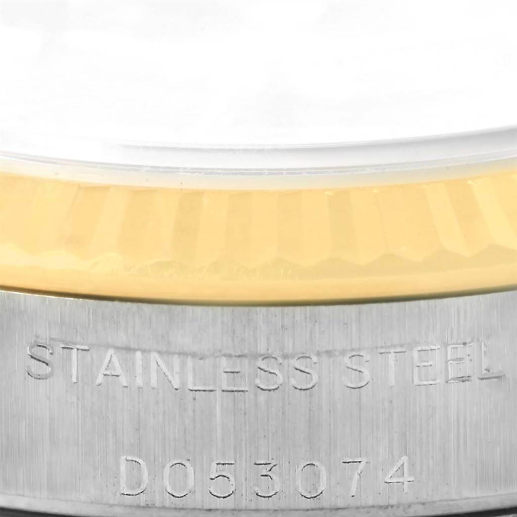 This close-up of a Rolex Oyster Perpetual 76193 Women's Steel and Gold (two tone) Black Dial 76193 Women's Steel and Gold (two tone) Black Dial watch shows the stainless steel case and partially the bezel.