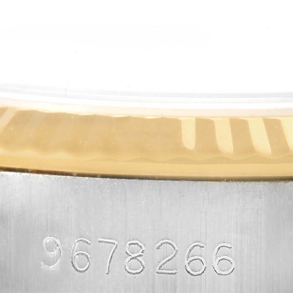 This image shows a close-up of the serial number and the edge of the bezel on a Rolex Oyster Perpetual 67193 Women
s Steel and Gold (two tone) Champagne Dial 67193 Women
s Steel and Gold (two tone) Champagne Dial watch.