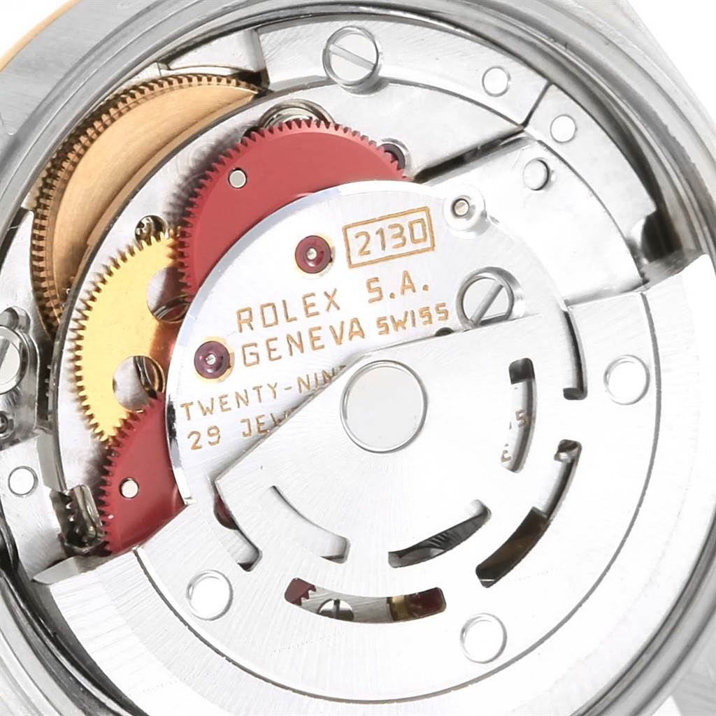 This is a close-up view of the internal mechanism of the Rolex Oyster Perpetual 67193 Women
s Steel and Gold (two tone) Champagne Dial 67193 Women
s Steel and Gold (two tone) Champagne Dial watch, showing gears and movement parts.