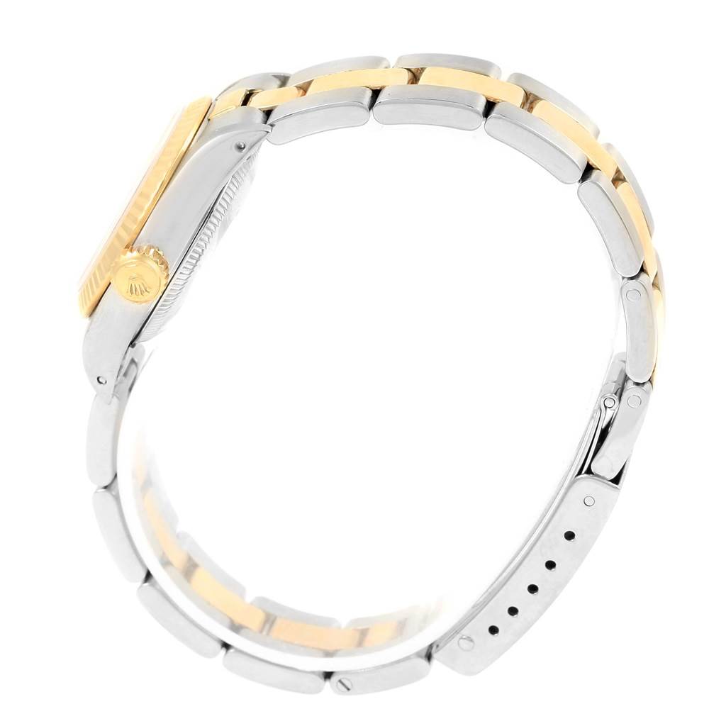 This side view of the Rolex Oyster Perpetual 67193 Women
s Steel and Gold (two tone) Champagne Dial 67193 Women
s Steel and Gold (two tone) Champagne Dial watch highlights its two-tone bracelet and crown.