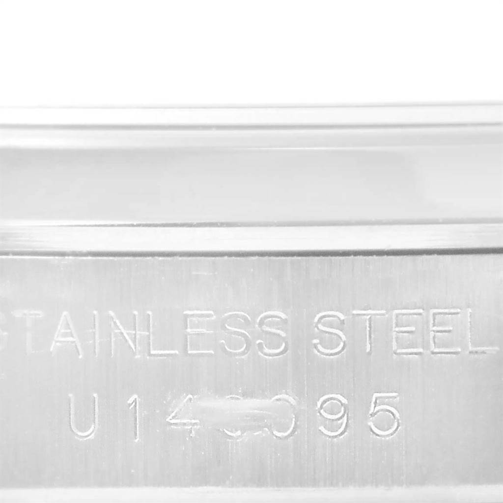 This image shows a close-up of the side casing with engraved details of a Rolex Oyster Perpetual 67180 Women's Stainless Steel Black Dial 67180 Women's Stainless Steel Black Dial watch.