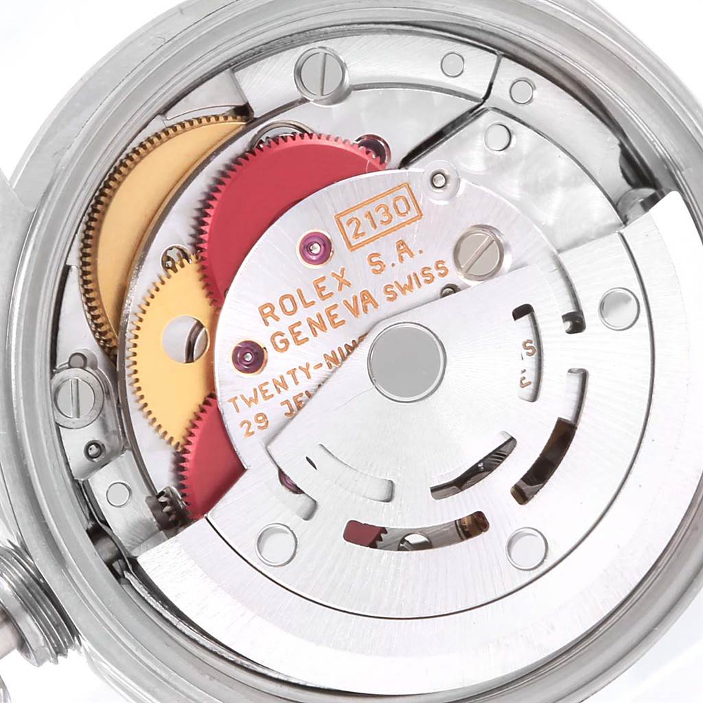 The image shows the internal mechanism of a Rolex Oyster Perpetual 67180 Women's Stainless Steel Black Dial 67180 Women's Stainless Steel Black Dial watch, highlighting gears, the rotor, and other components.