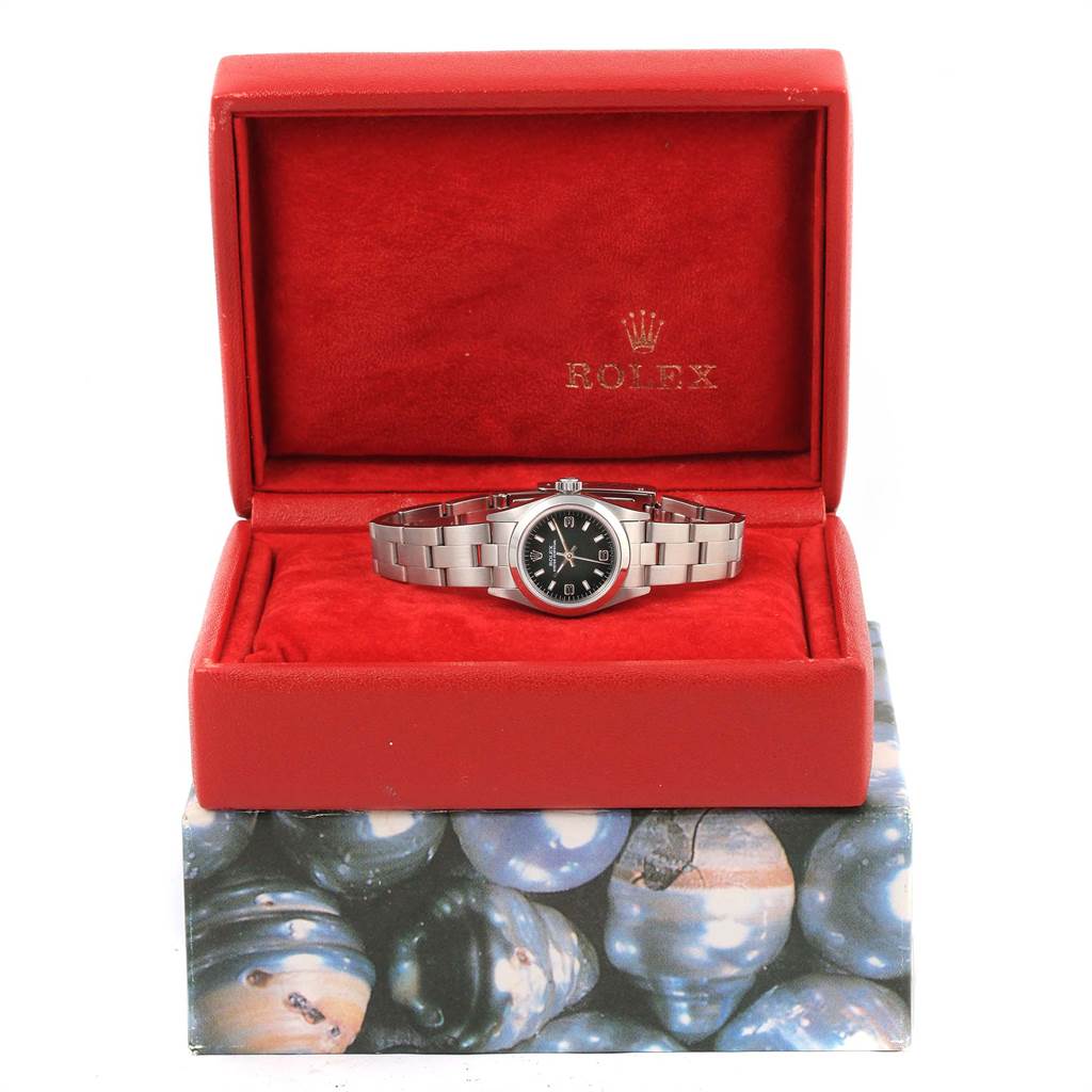 The image shows a Rolex Oyster Perpetual 67180 Women's Stainless Steel Black Dial 67180 Women's Stainless Steel Black Dial watch in its red case, viewed from the front.