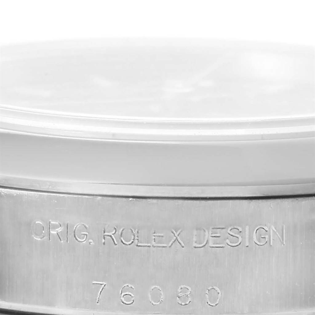 This image shows the side view of a Rolex Oyster Perpetual 76080 Women
s Stainless Steel Black Dial 76080 Women
s Stainless Steel Black Dial watch, highlighting its case with engraved model number 76080.