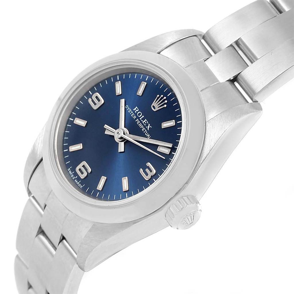 This image shows the Rolex Oyster Perpetual 76080 Women
s Stainless Steel Blue Dial 76080 Women
s Stainless Steel Blue Dial watch at an angle, highlighting its blue dial, winding crown, and links of the bracelet.