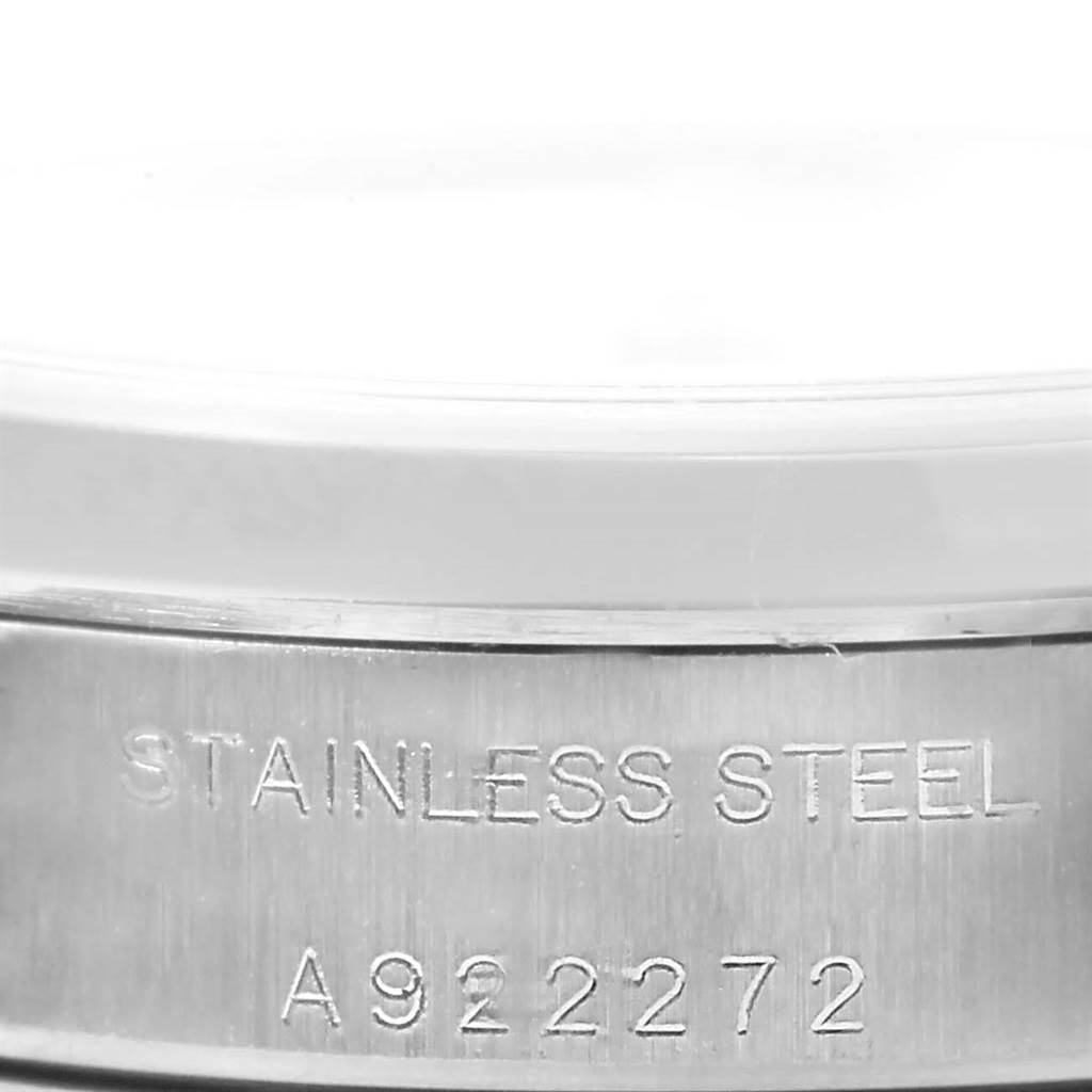 The image shows a close-up of the case back side of a Rolex Oyster Perpetual 76080 Women
s Stainless Steel White Dial 76080 Women
s Stainless Steel White Dial watch, highlighting the "STAINLESS STEEL" engraving.