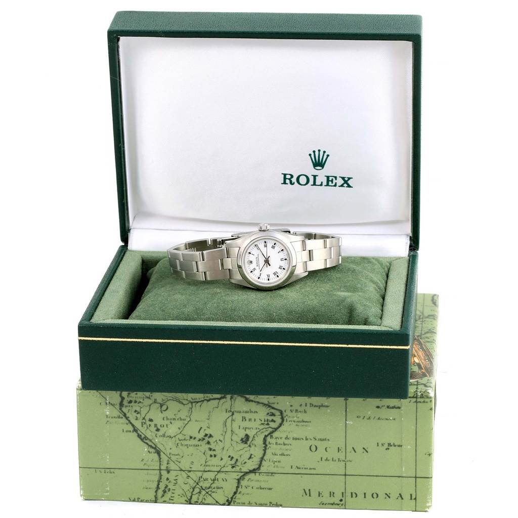 The image shows a Rolex Oyster Perpetual 76080 Women
s Stainless Steel White Dial 76080 Women
s Stainless Steel White Dial watch placed inside its open green and white branded box at a front angle.