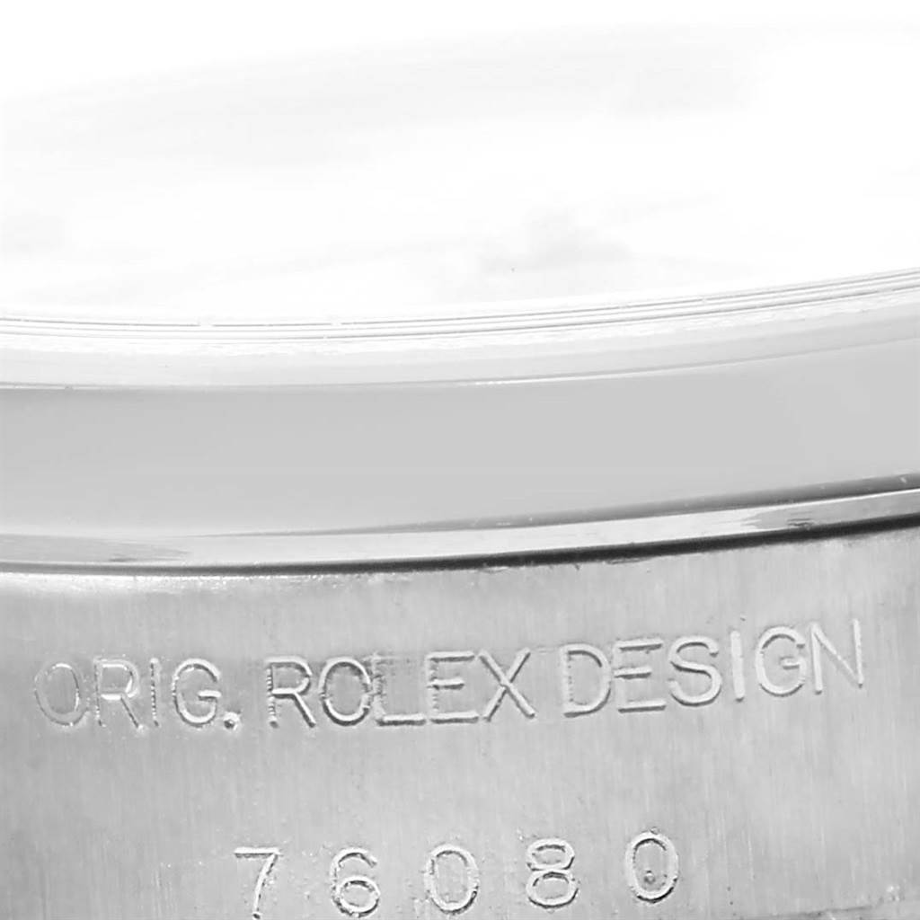 This image shows a close-up of the side engraving on the case of a Rolex Oyster Perpetual 76080 Women
s Stainless Steel White Dial 76080 Women
s Stainless Steel White Dial watch.
