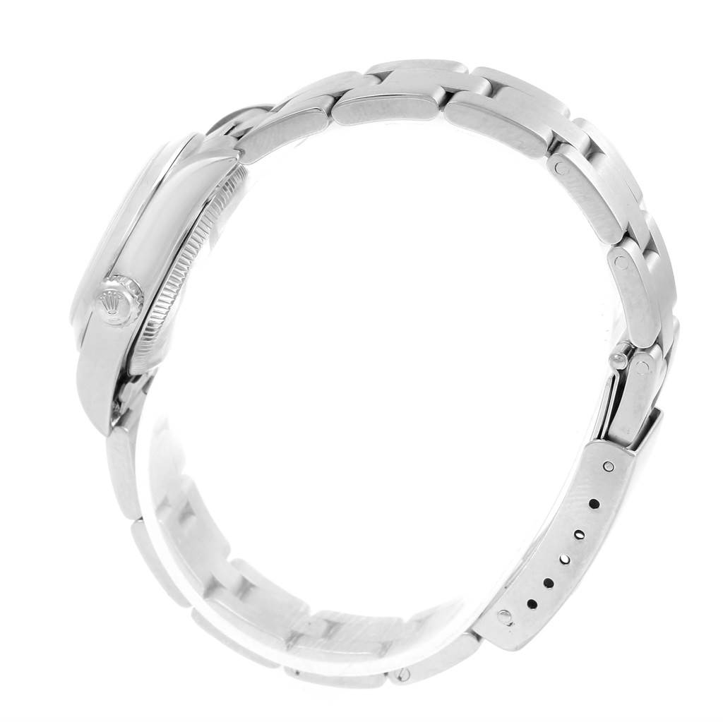 The image shows a side view of the Rolex Oyster Perpetual 76080 Women
s Stainless Steel White Dial 76080 Women
s Stainless Steel White Dial watch, highlighting the case, crown, and bracelet.