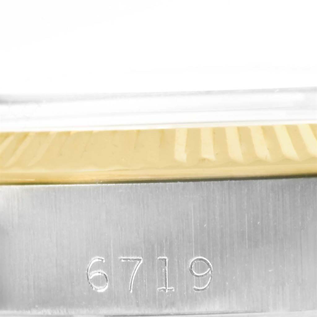 This image shows a detailed view of the reference number "6719" on the side of the Rolex Oyster Perpetual 6719 Women's Steel and Gold (two tone) Champagne Dial 6719 Women's Steel and Gold (two tone) Champagne Dial watch case.