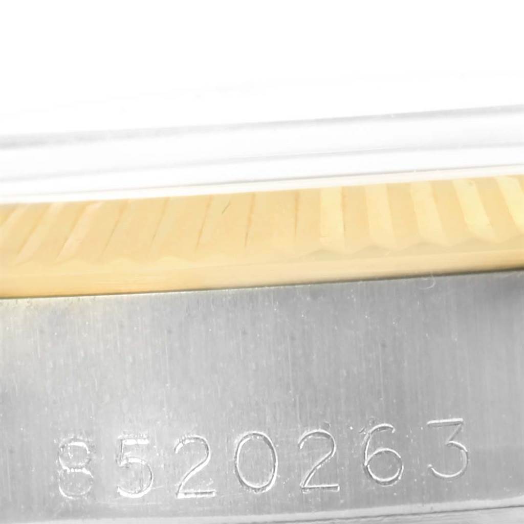 The image shows the serial number engraved on the side of the case of a Rolex Oyster Perpetual 6719 Women's Steel and Gold (two tone) Champagne Dial 6719 Women's Steel and Gold (two tone) Champagne Dial watch.
