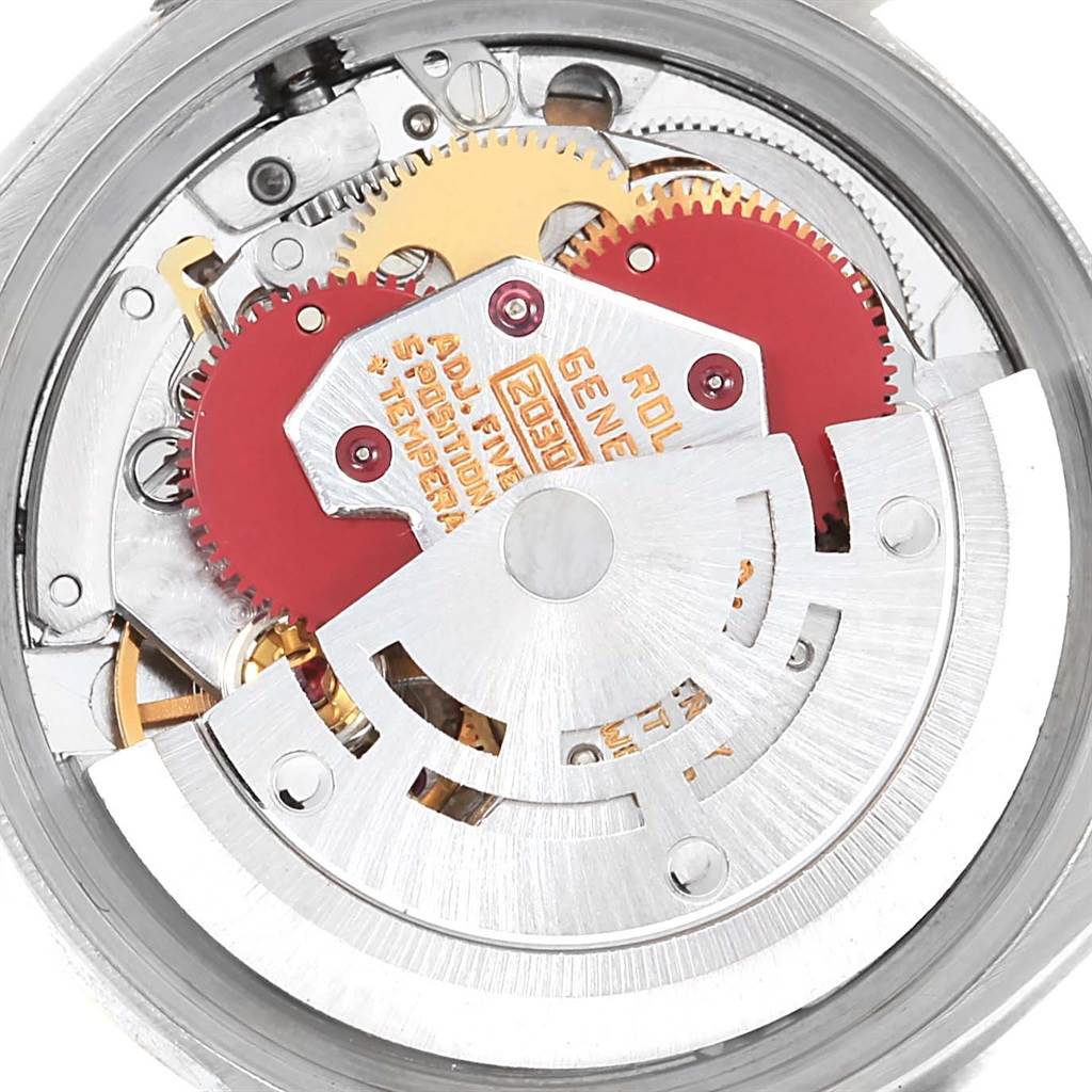 This is an inside view of the Rolex Oyster Perpetual 6719 Women's Steel and Gold (two tone) Champagne Dial 6719 Women's Steel and Gold (two tone) Champagne Dial watch, showing its intricate movement and gears.