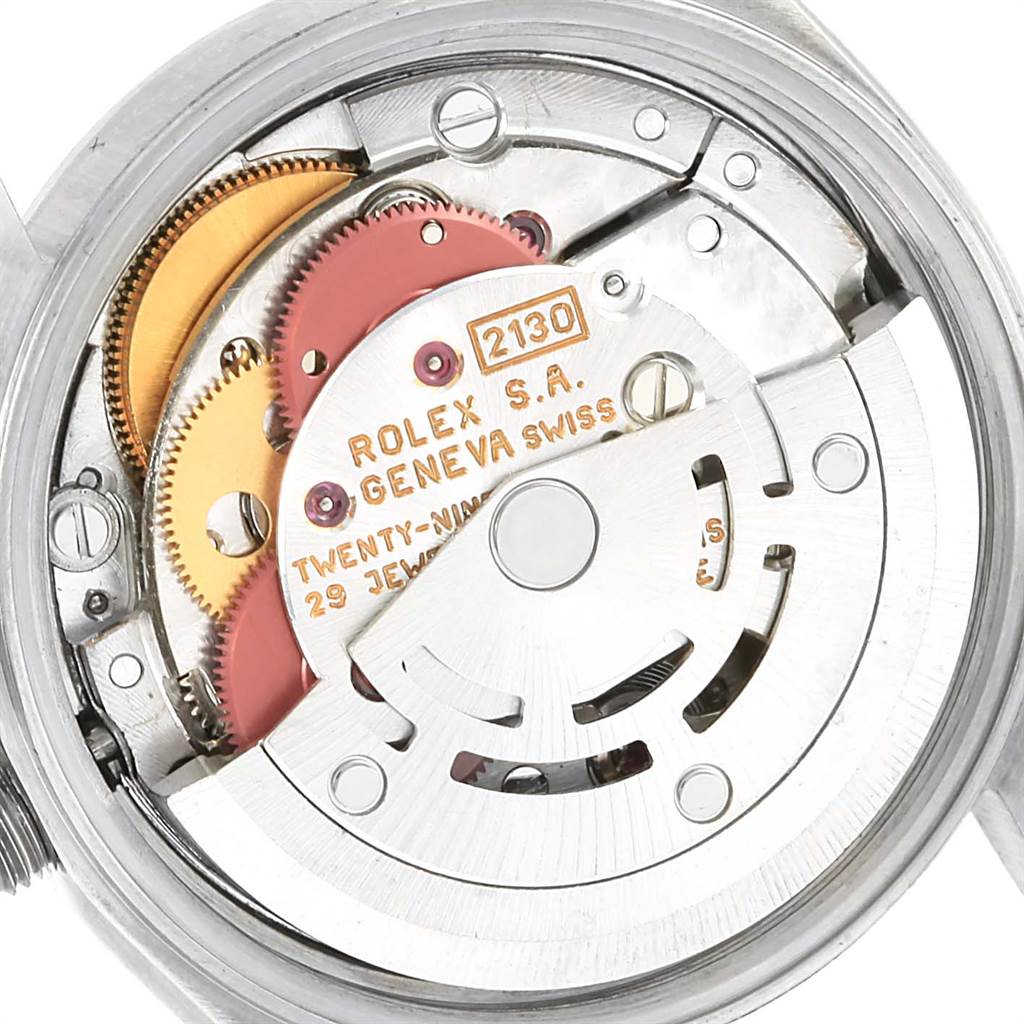 This image shows the internal mechanism and movement of a Rolex Oyster Perpetual 67180 Women
s Stainless Steel Blue Dial 67180 Women
s Stainless Steel Blue Dial watch, including gears and inscriptions.