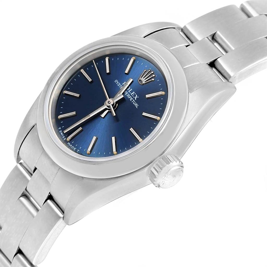This image shows a close-up angled view of a Rolex Oyster Perpetual 67180 Women
s Stainless Steel Blue Dial 67180 Women
s Stainless Steel Blue Dial watch, focusing on its blue dial, bezel, and crown.
