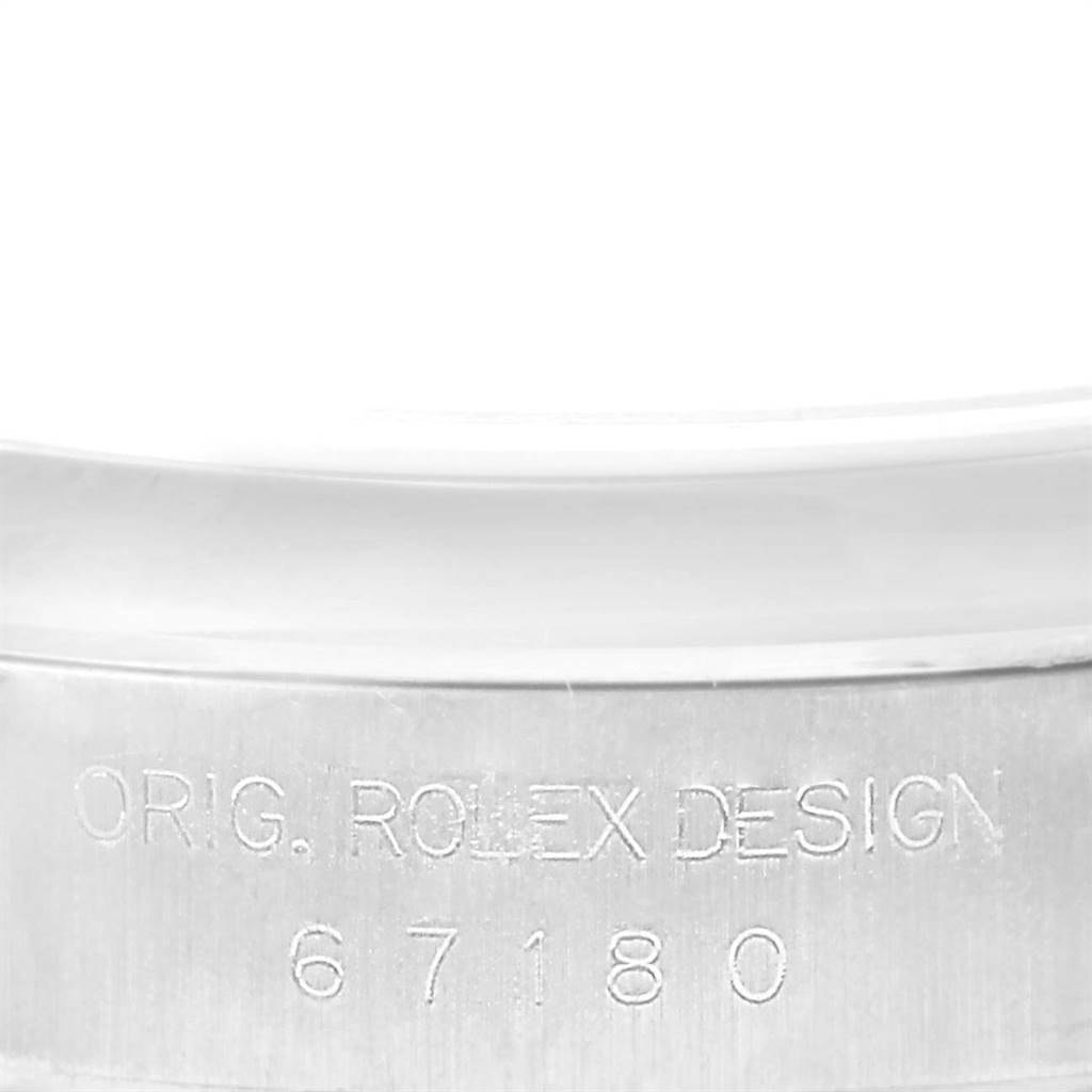 The image shows a close-up of the case side of a Rolex Oyster Perpetual 67180 Women
s Stainless Steel Blue Dial 67180 Women
s Stainless Steel Blue Dial watch, displaying "ORIG. ROLEX DESIGN 67180".