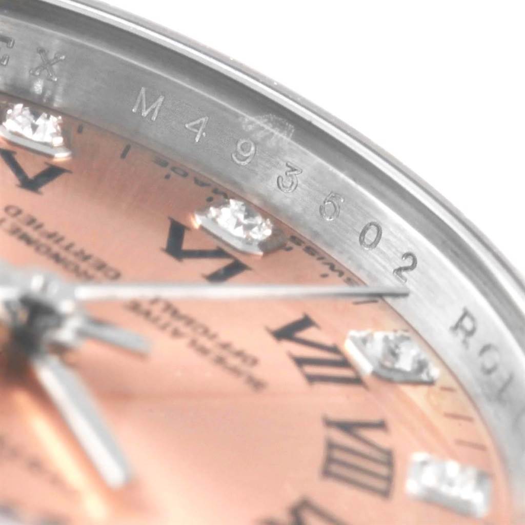 This image shows a close-up of the dial and part of the bezel with an engraved serial number on the Rolex Oyster Perpetual 176234 Women
s Stainless Steel Pink Dial 176234 Women
s Stainless Steel Pink Dial watch.