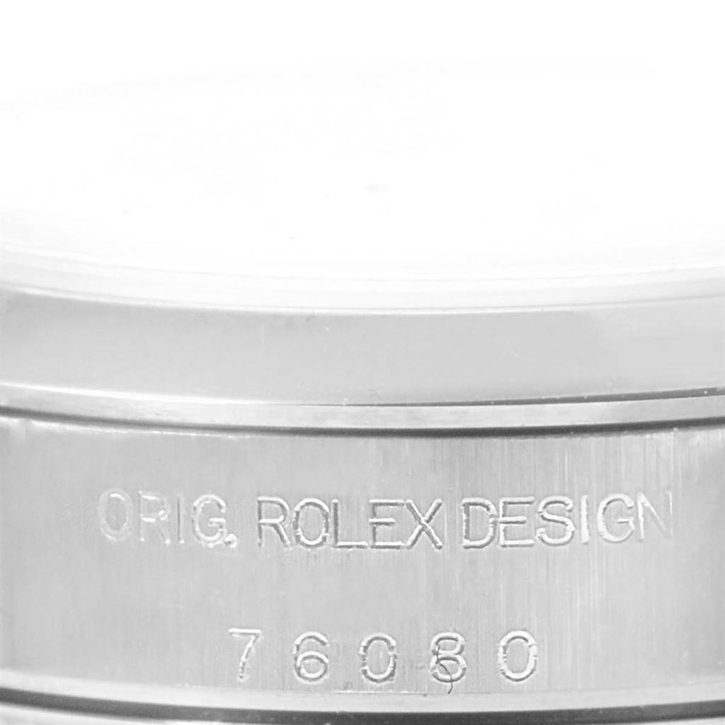 This image shows a close-up of the case back edge on an Oyster Perpetual Rolex watch with engraved text.