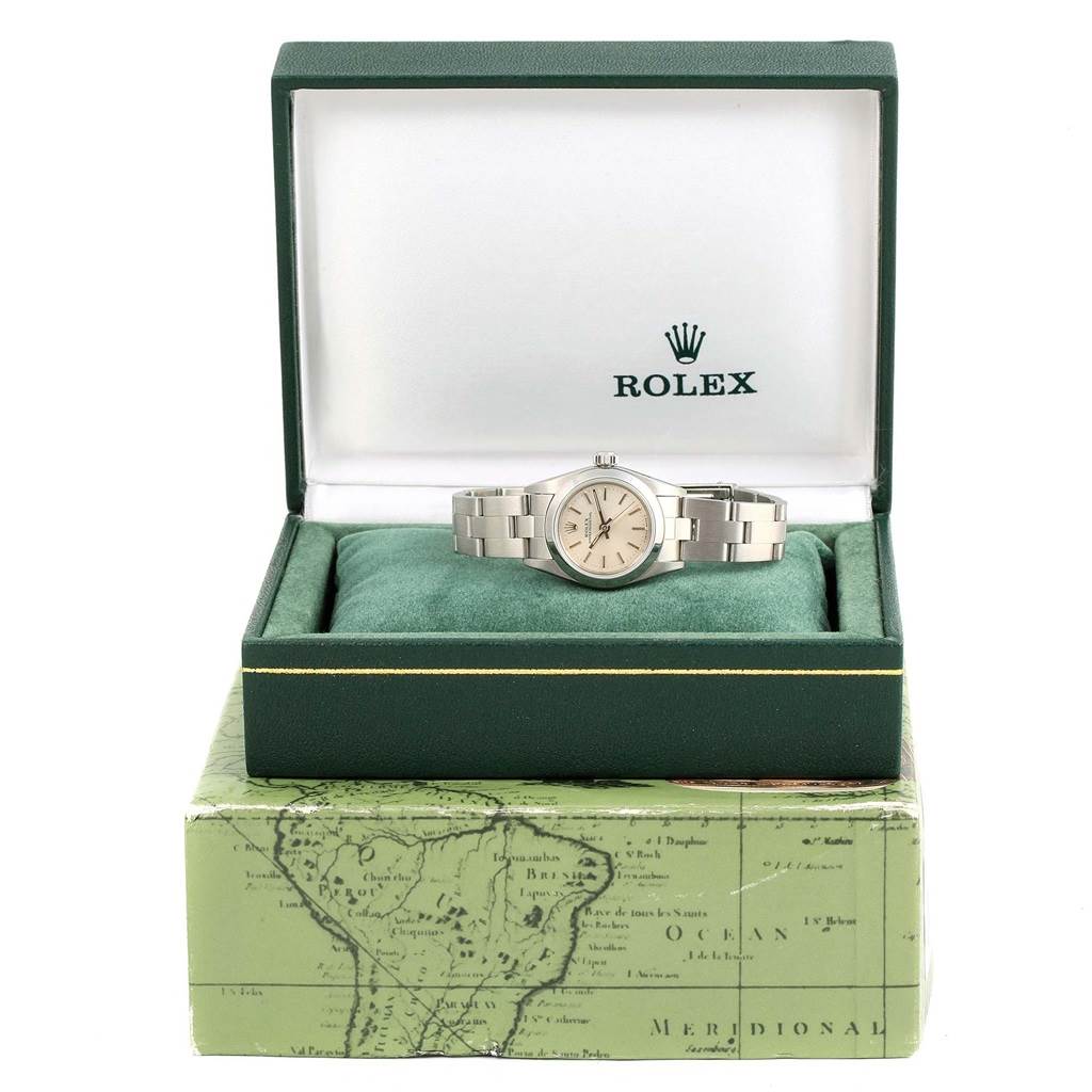 The Rolex Oyster Perpetual 67180 Women
s Stainless Steel Silver Dial 67180 Women
s Stainless Steel Silver Dial watch is shown from a front angle, in an open green box.