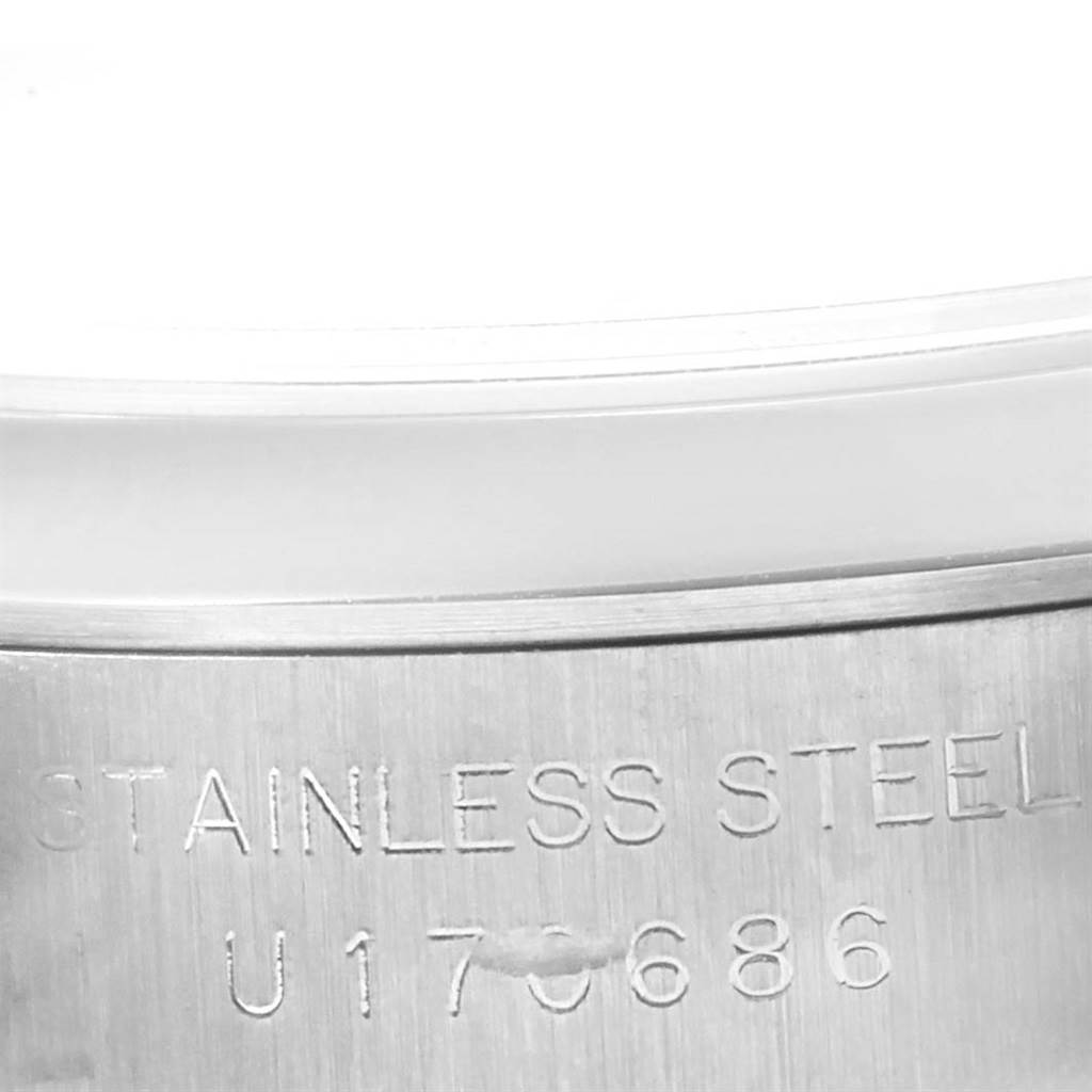 This image shows a close-up of the stainless steel casing with the serial number of a Rolex Oyster Perpetual 67180 Women
s Stainless Steel Silver Dial 67180 Women
s Stainless Steel Silver Dial watch.