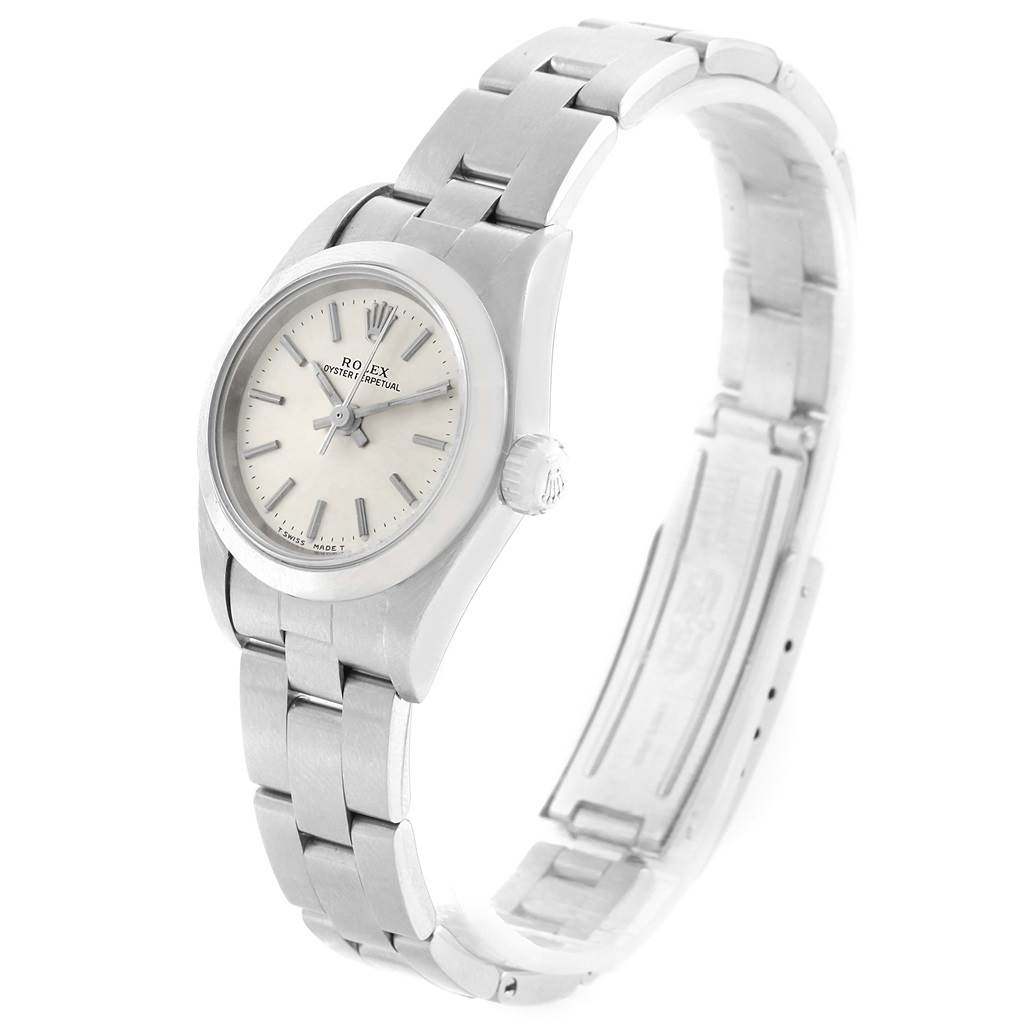 The Oyster Perpetual Rolex watch is shown in a tilted side view, displaying the face, case, and bracelet.