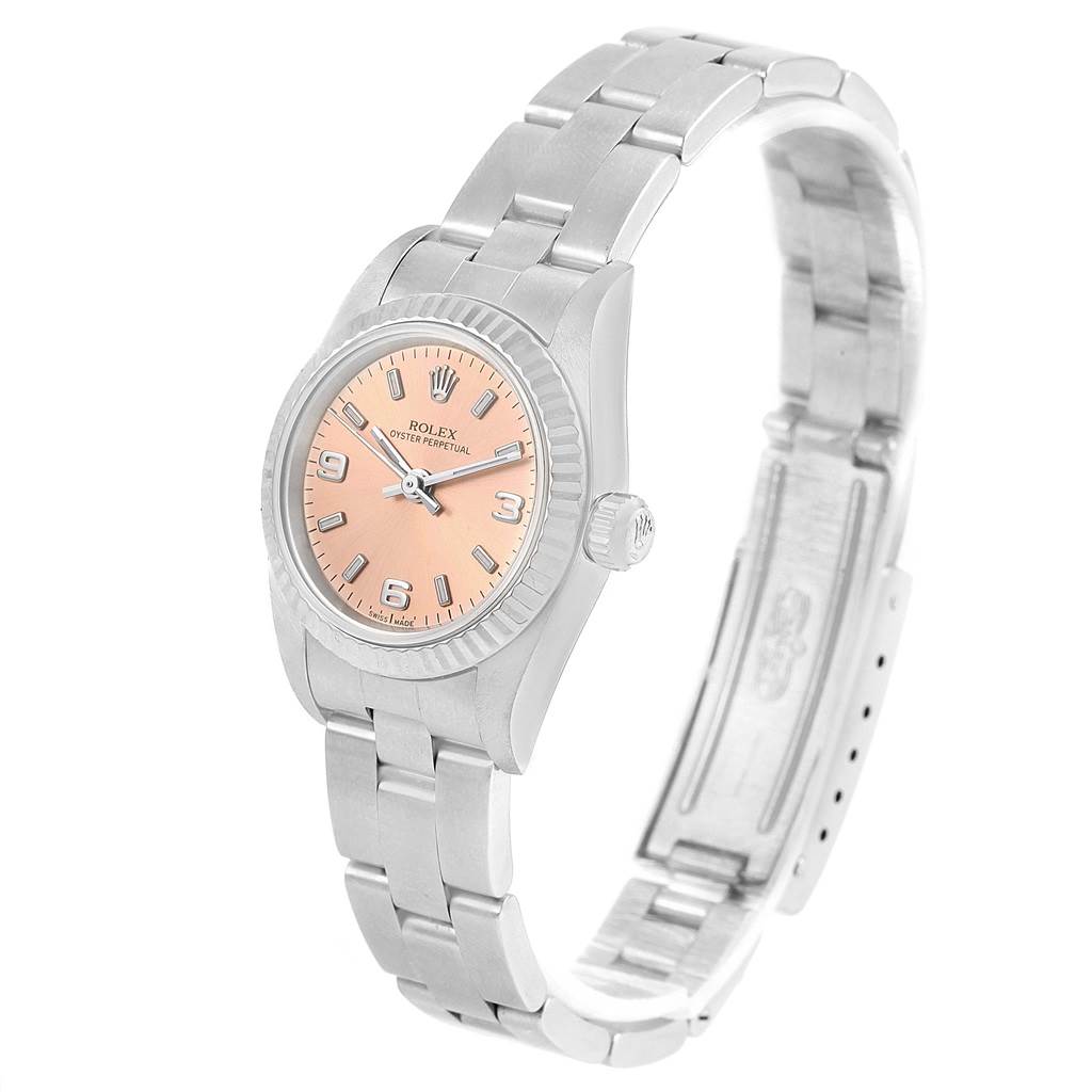 The Rolex Oyster Perpetual 76094 Women
s Stainless Steel Pink Dial 76094 Women
s Stainless Steel Pink Dial watch is shown at a slight angle, revealing the face, bezel, crown, and bracelet.