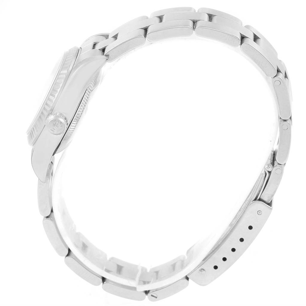 The image shows a side view of a Rolex Oyster Perpetual 76094 Women
s Stainless Steel Pink Dial 76094 Women
s Stainless Steel Pink Dial watch focusing on its bracelet and crown.