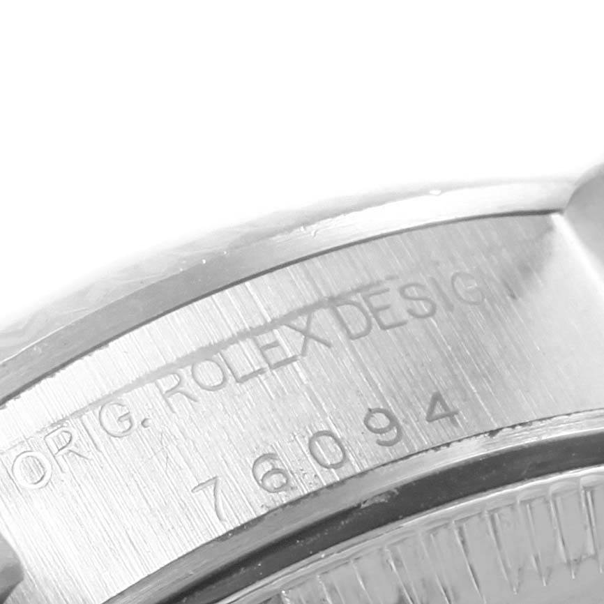 This close-up image shows the serial number and part of the casing of a Rolex Oyster Perpetual 76094 Women
s Stainless Steel Pink Dial 76094 Women
s Stainless Steel Pink Dial watch.
