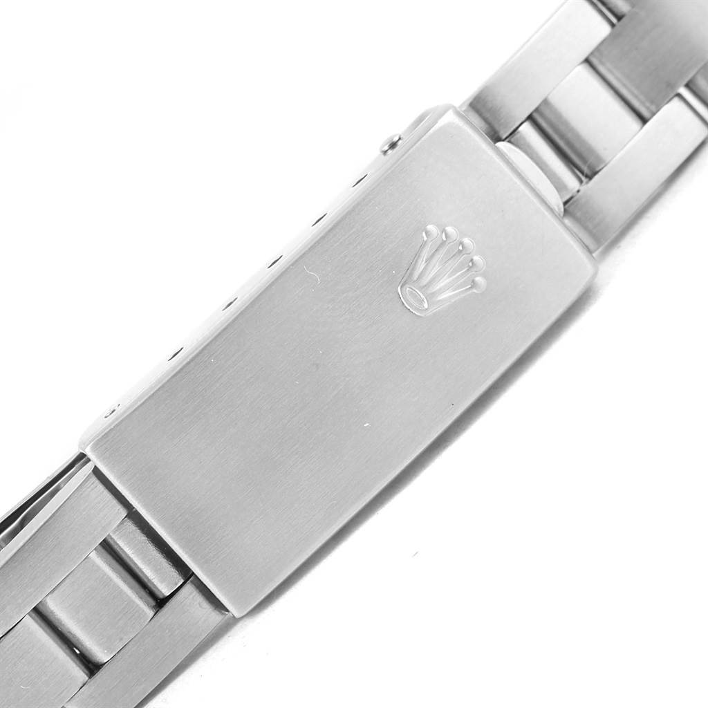 The image shows a close-up shot of the clasp and part of the bracelet of a Rolex Oyster Perpetual 67180 Women
s Stainless Steel Silver Dial 67180 Women
s Stainless Steel Silver Dial watch.