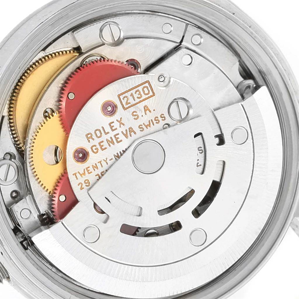 The image shows the internal movement parts of a Rolex Oyster Perpetual 67180 Women
s Stainless Steel Silver Dial 67180 Women
s Stainless Steel Silver Dial watch, including gears and the rotor, viewed from the back.